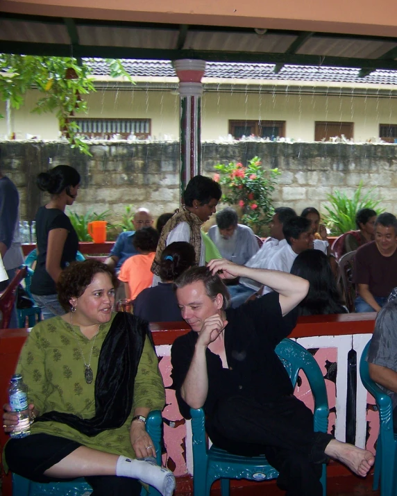 the group of people sit and sit on the colorful bench at the party