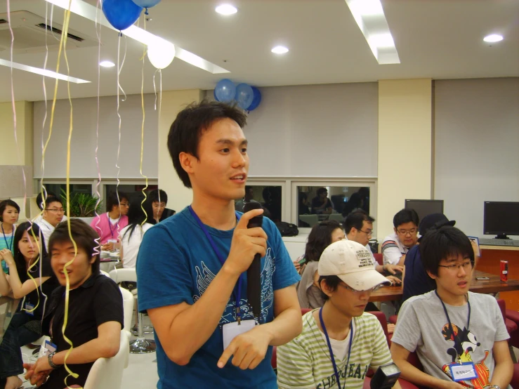 the young man in the hat is holding a microphone