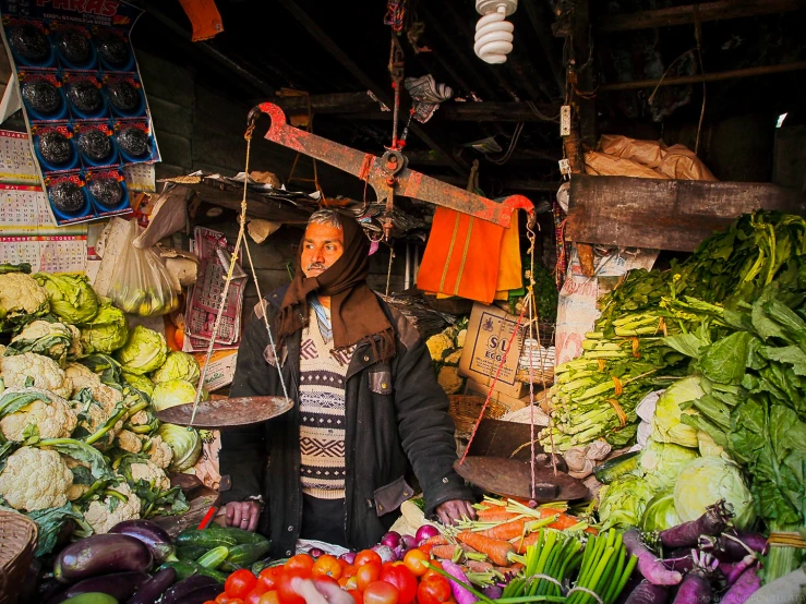 an image of man with food at market stall