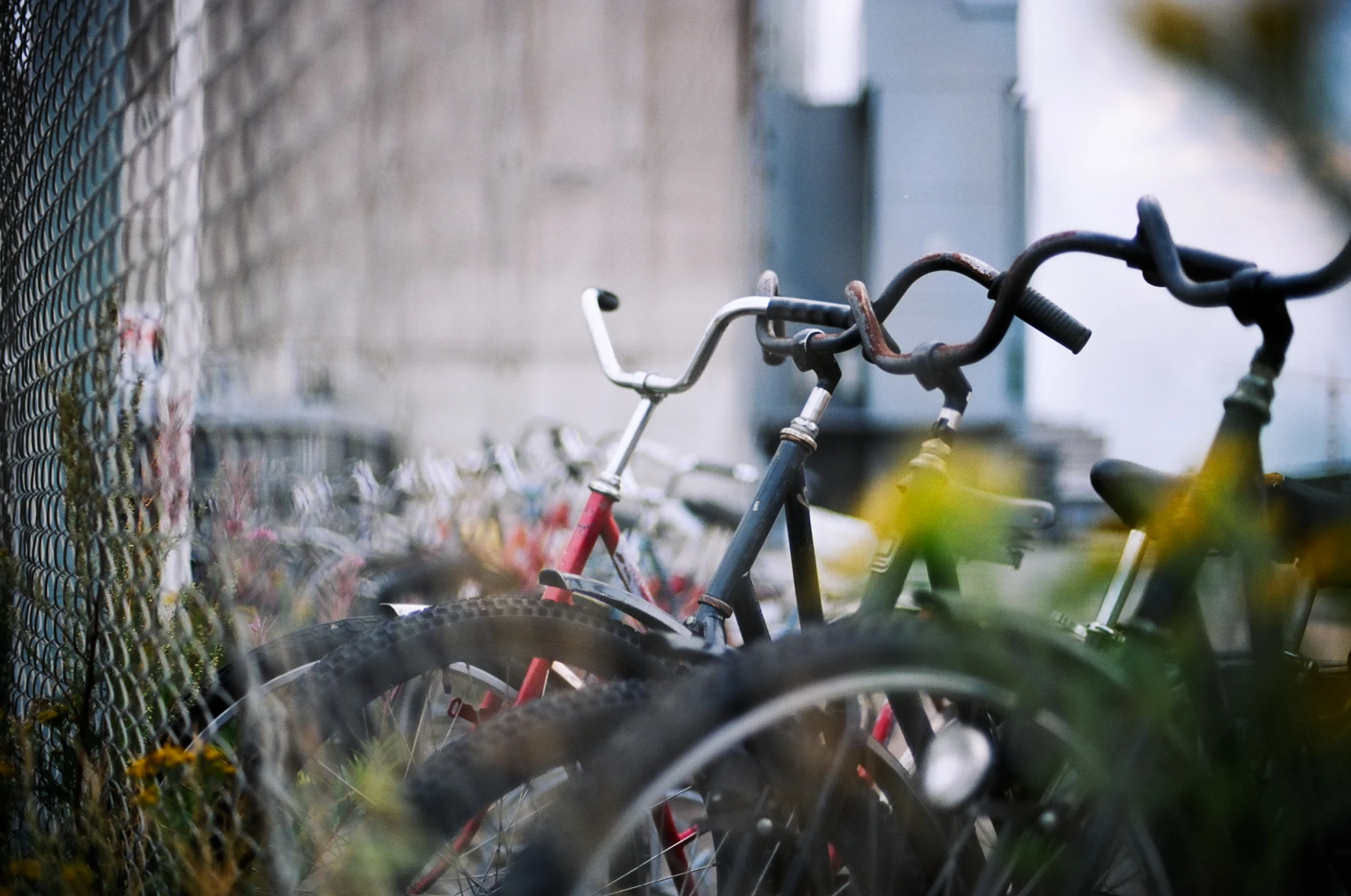 a bunch of bikes are parked in front of the fence