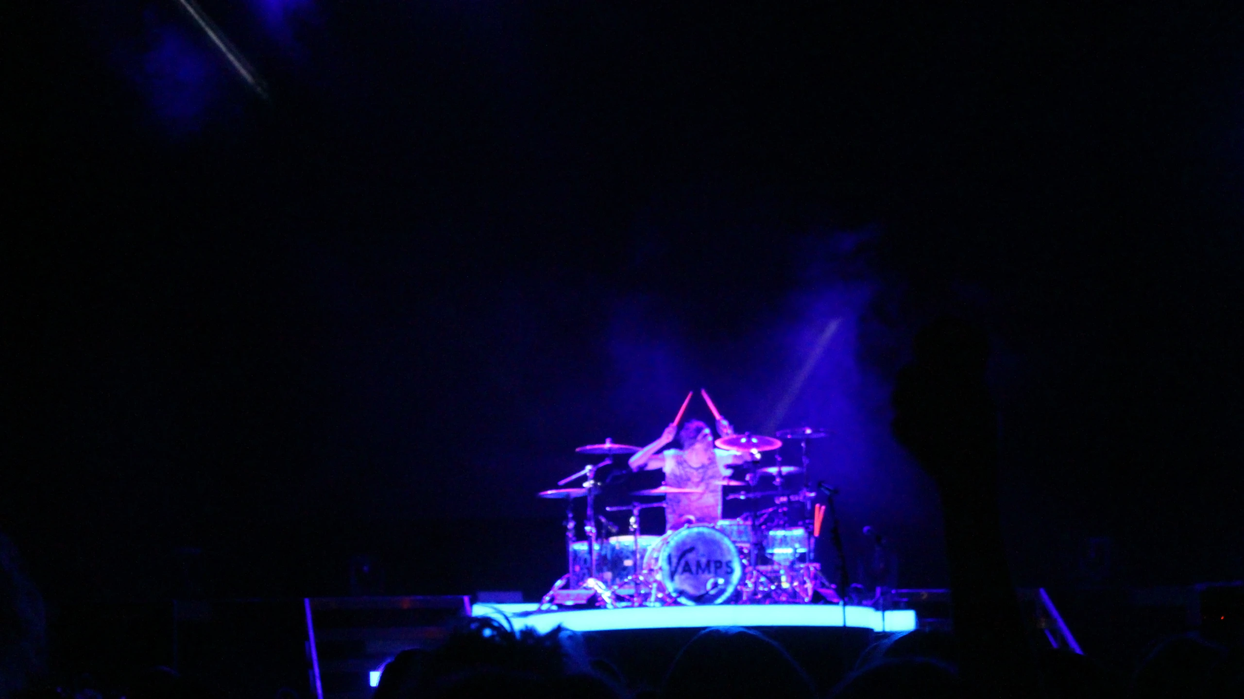 a person on stage with a big drumstick