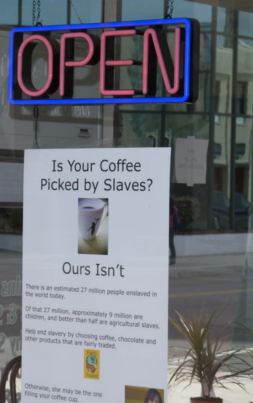 a sign posted near the windows of a coffee shop