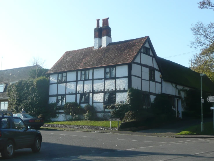 old house with unusual dormer roof and tall chimney