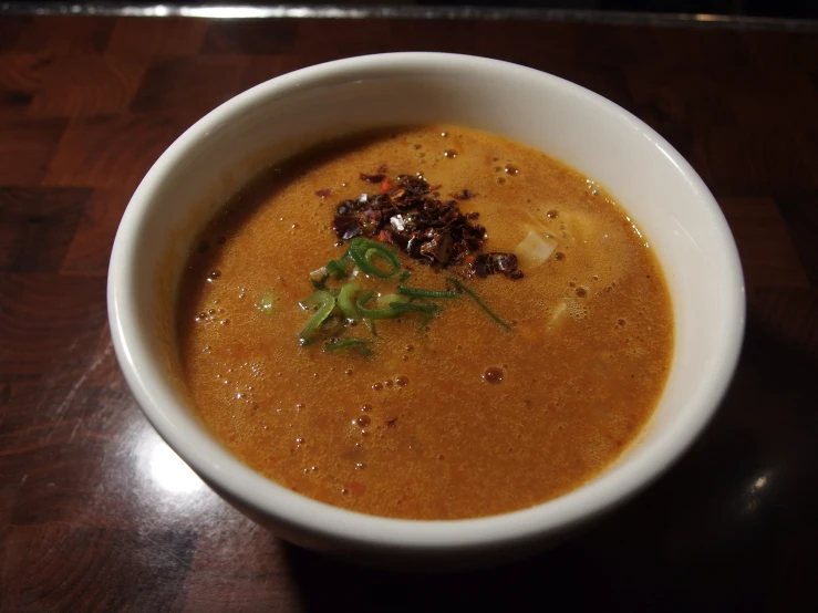 a white bowl filled with soup and garnished with a spoon