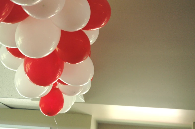 a bunch of balloons suspended from a ceiling