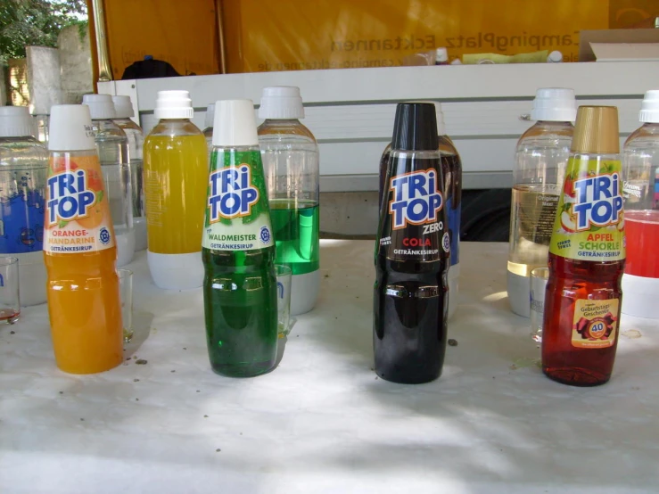 a white table topped with lots of bottles of liquid