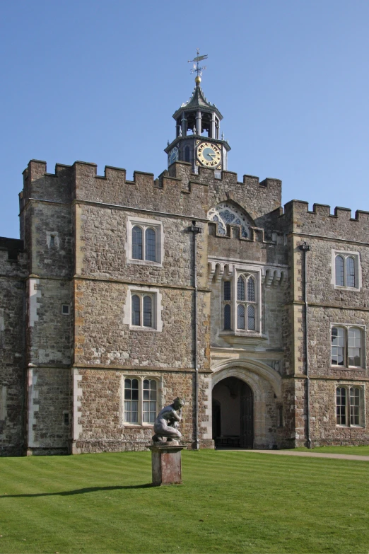 the old castle is built on a very green lawn