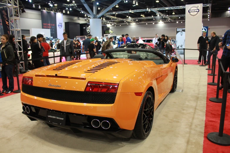 a sports car is sitting on display at a show