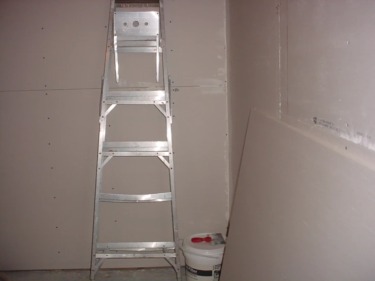 the ladder is being used to mount a toilet