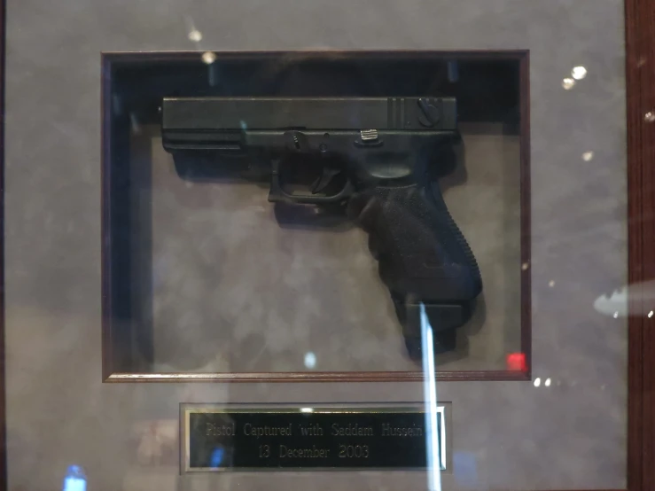 a gun displayed inside a case on a table