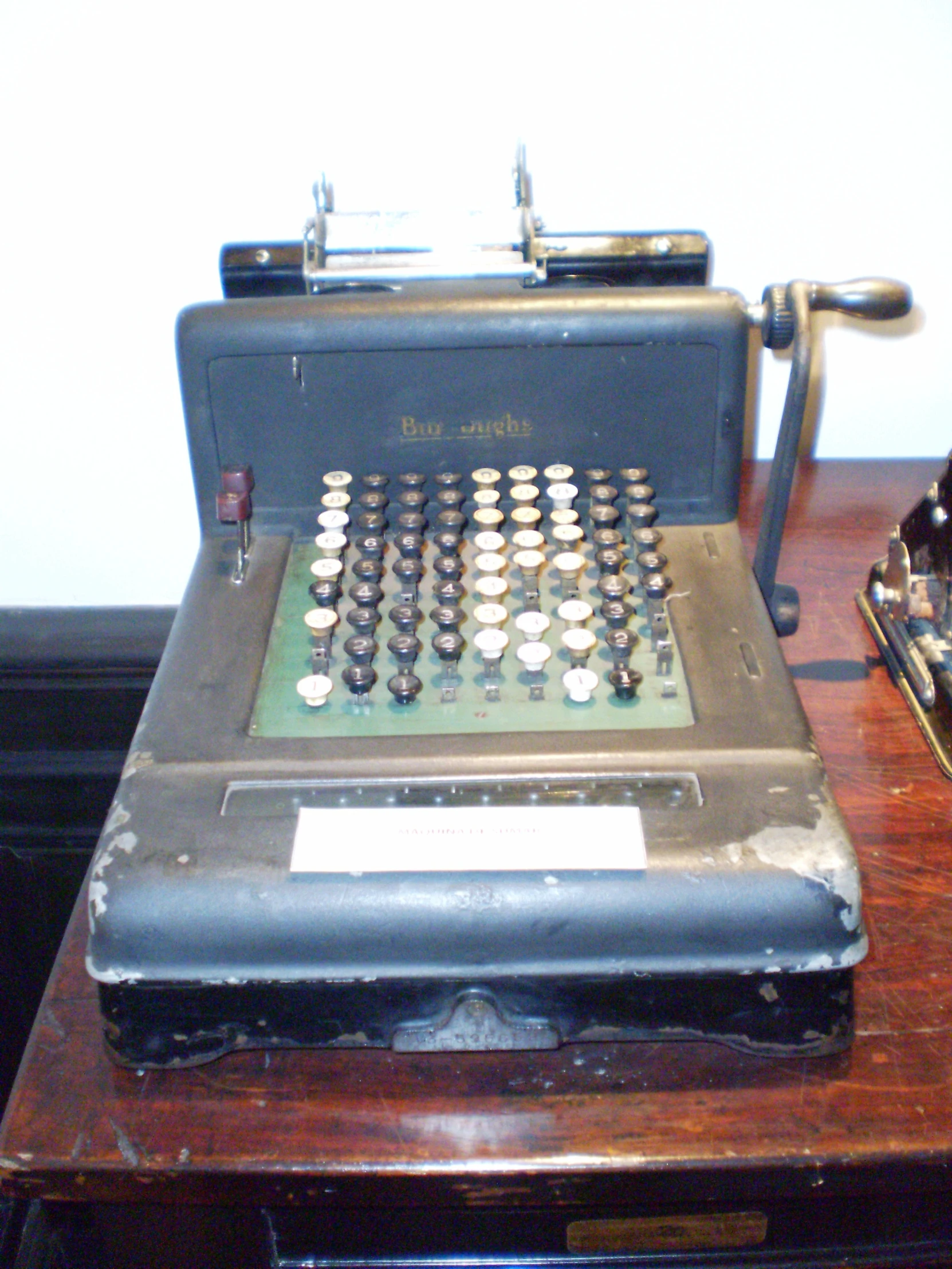 an old typewriter is on a wooden desk