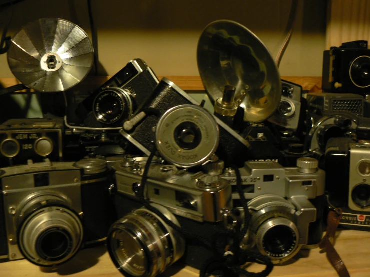 a bunch of old cameras sitting on a table