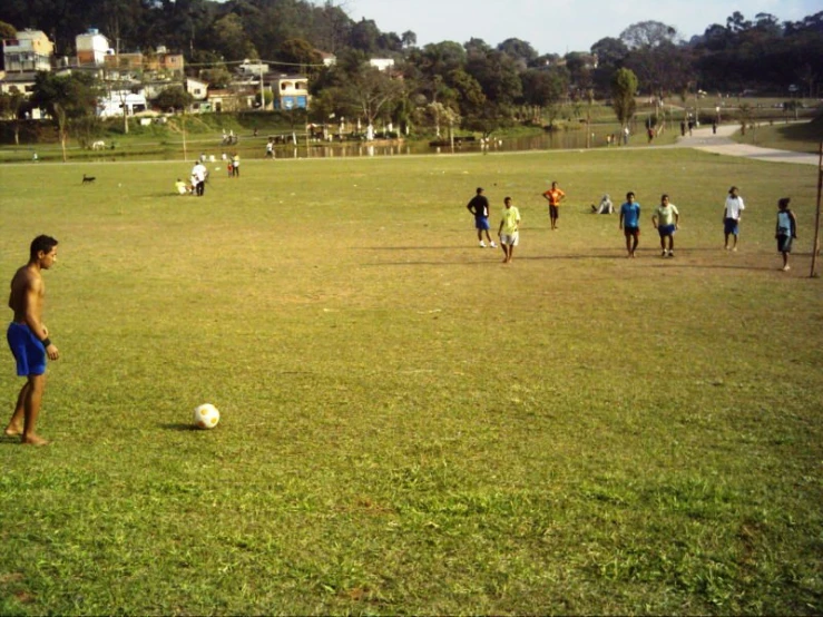 young men play soccer in the grassy field