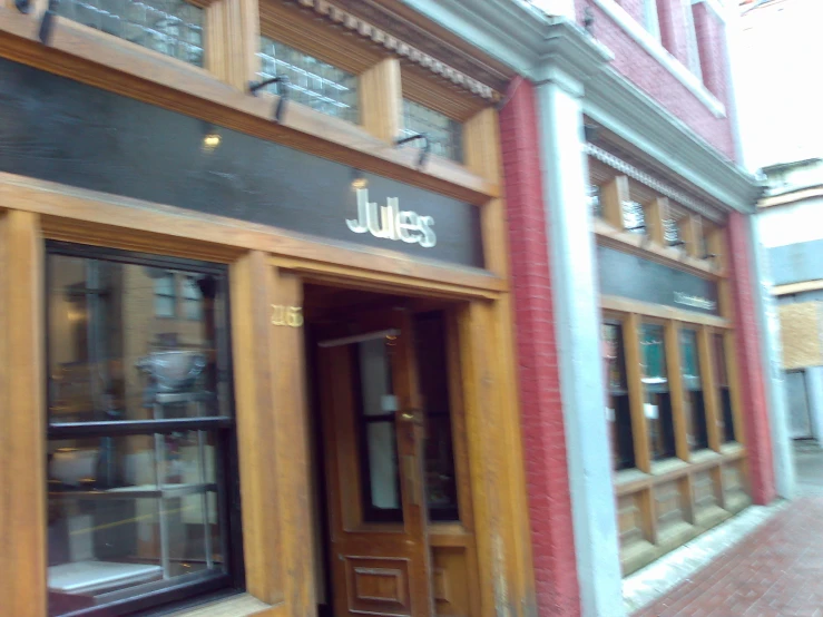 a building with multiple windows and wood doors