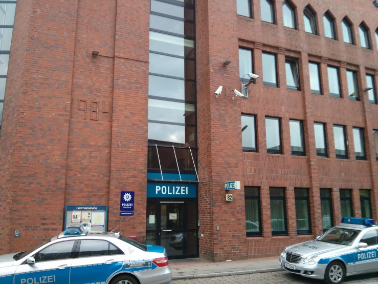 two police cars parked outside of a building