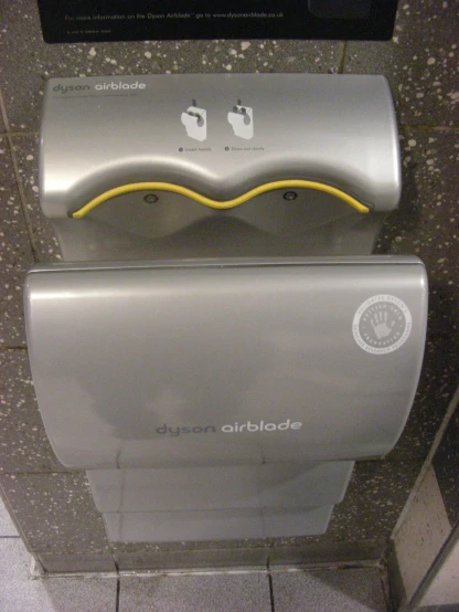 a shiny metallic urinal with no water