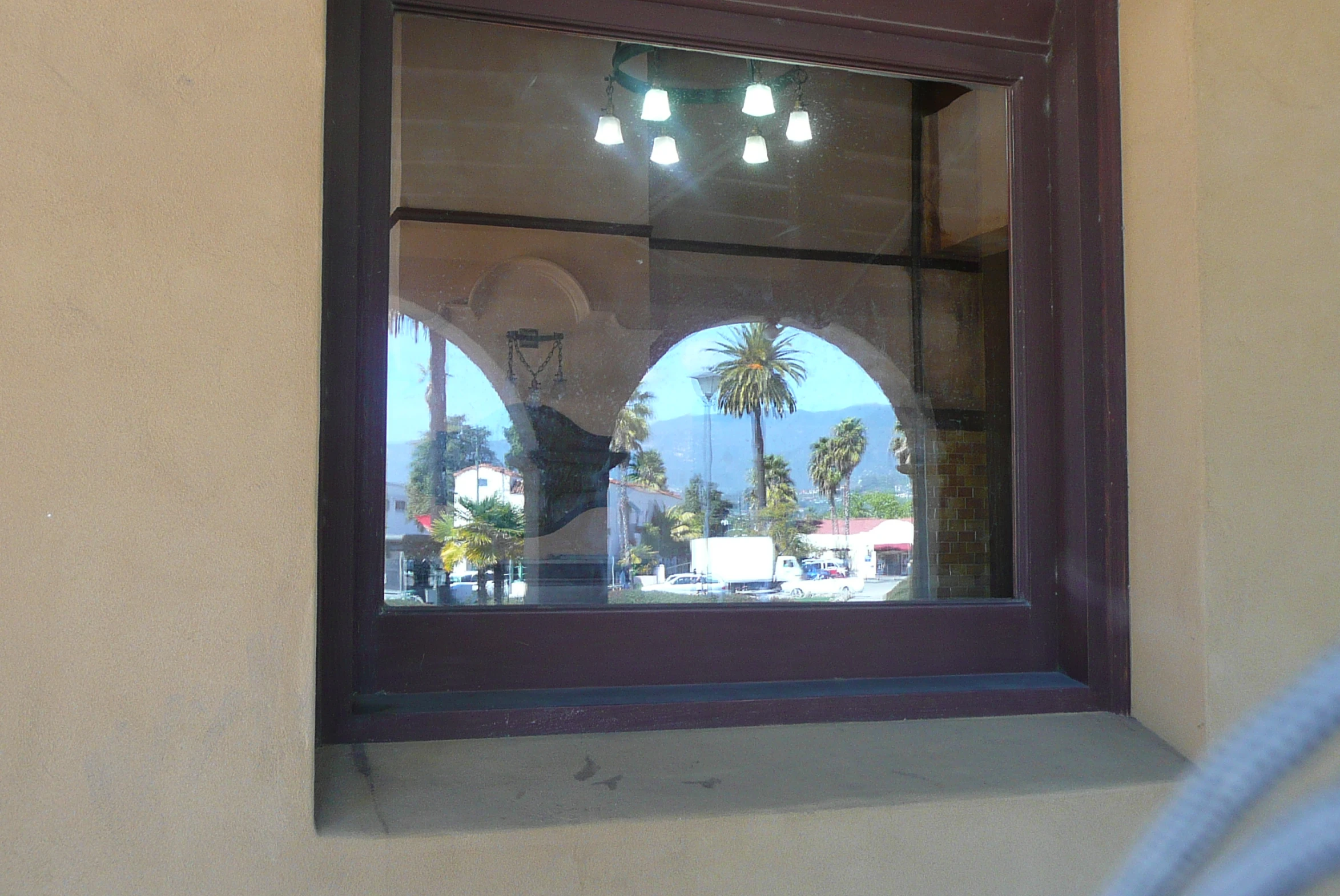 the reflection of two lights in the window of a building