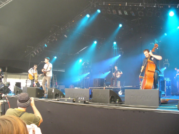 musicians performing on the stage at a concert