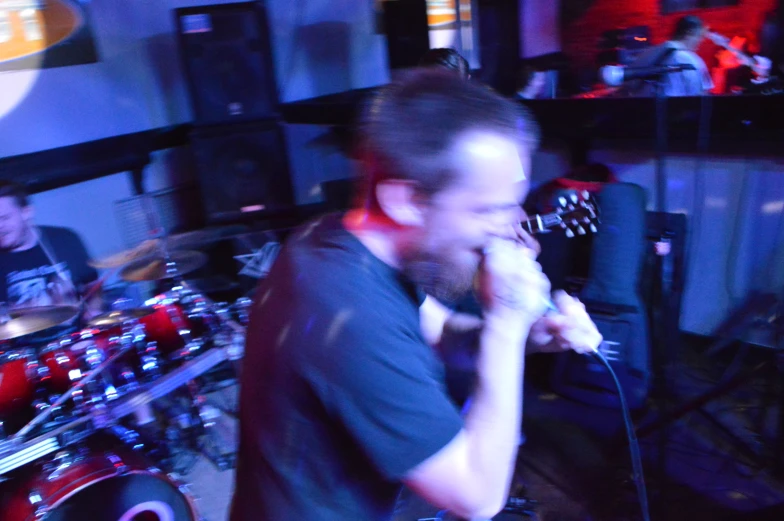 a band playing in a dark room on keyboards