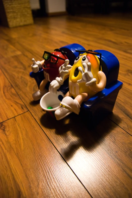 small toy vehicles sitting in the middle of a wooden floor