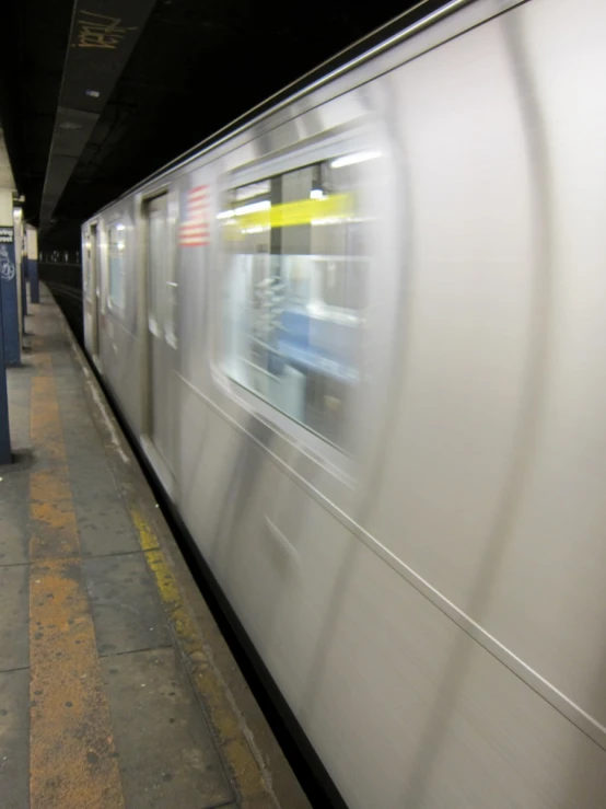 a train speeds by on its tracks while it's blurry