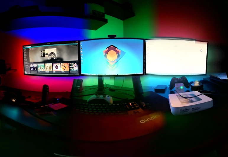 several computer monitors set up on a table