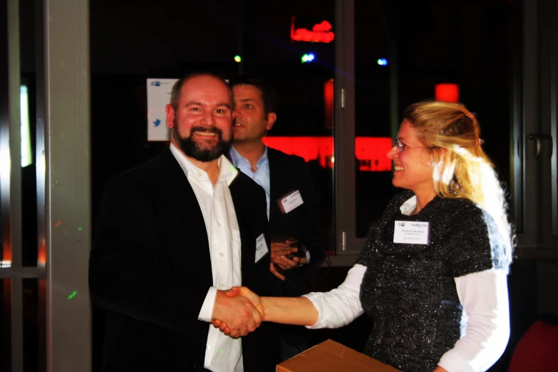 two women shaking hands at a business event