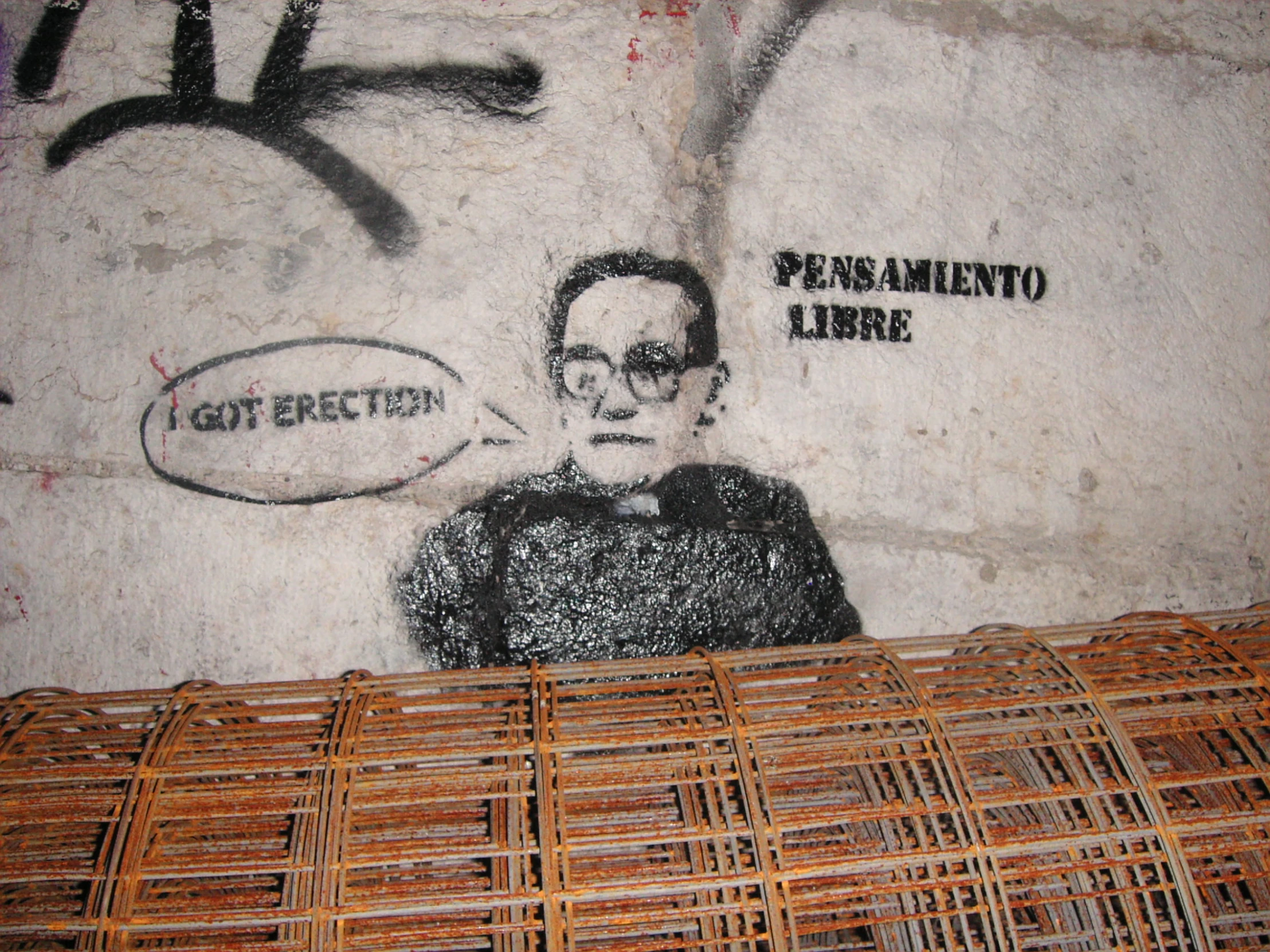 a wall with some writing on it and a person holding a frisbee