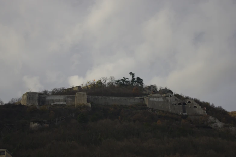 a very large building is sitting on a hill