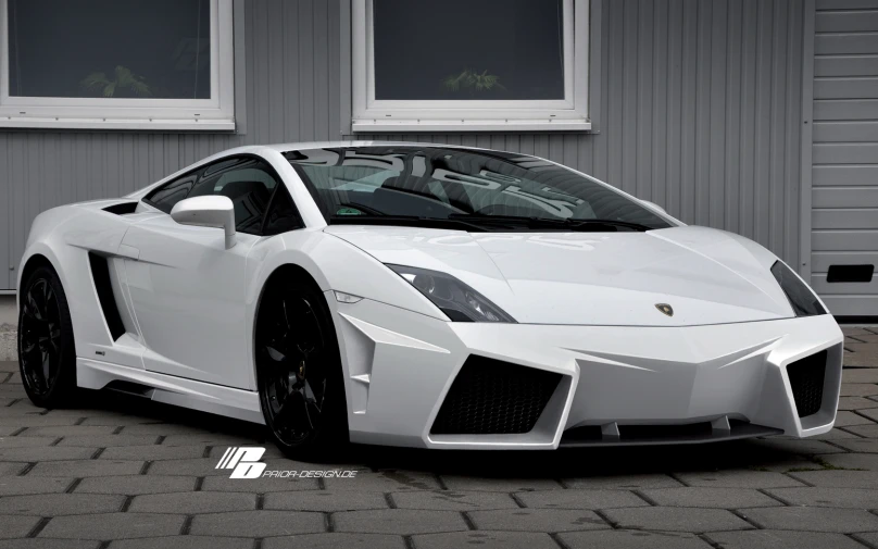 a white sports car is parked near a building