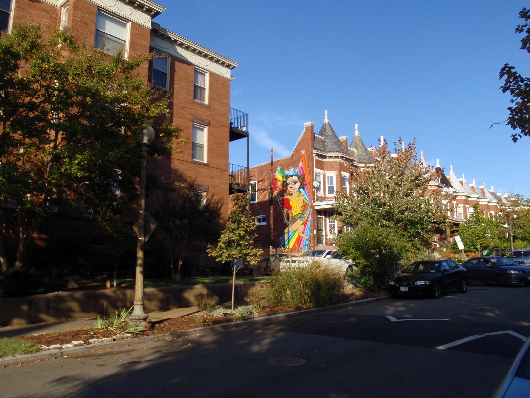 the cars are parked on the street next to the buildings