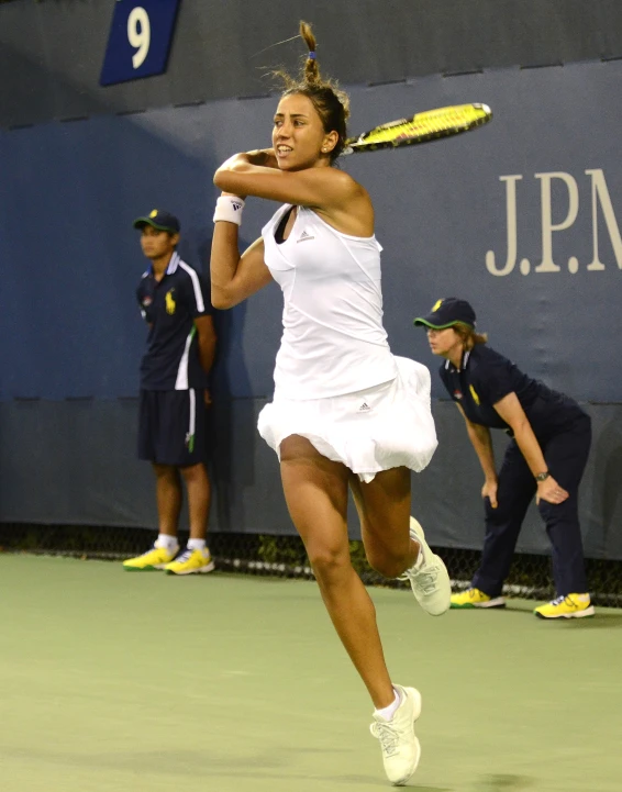 the woman is hitting the tennis ball with a tennis racket