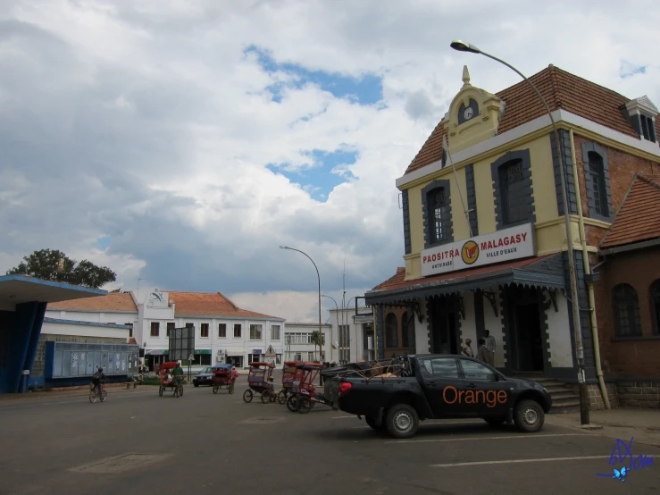 a truck parked in front of a small restaurant