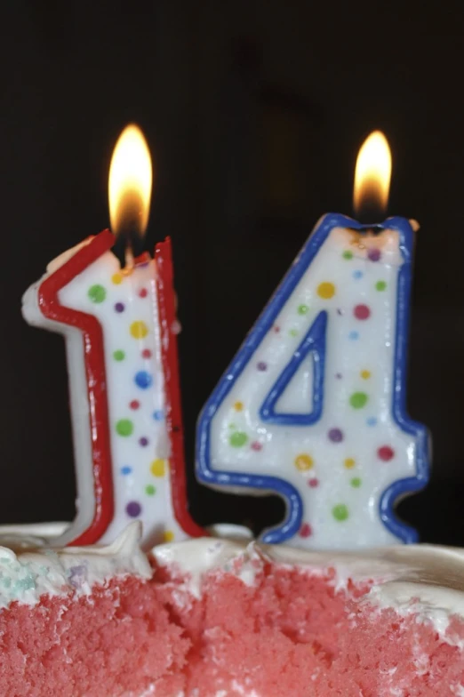 a birthday cake with a red cake with two candles on it