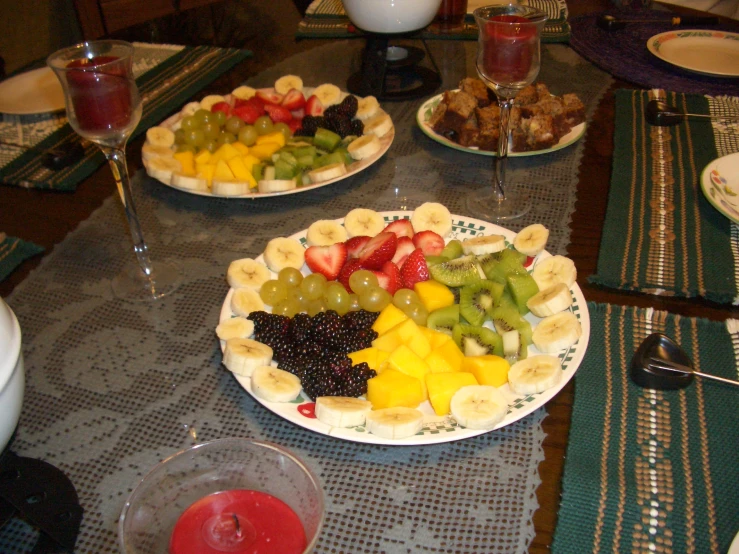 three plates have fruits on them and another plate is full