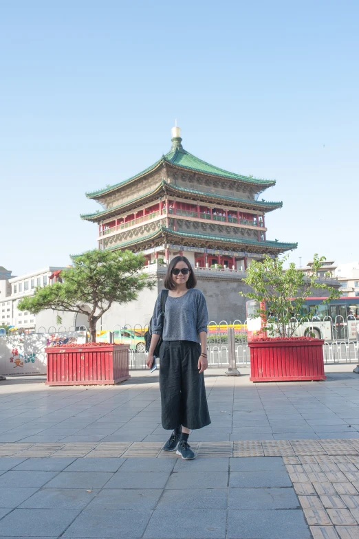 woman standing in front of an old building