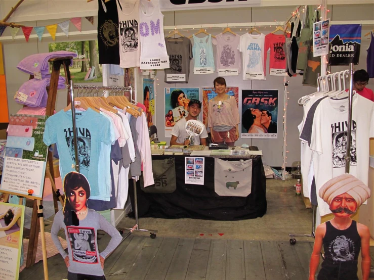 there are many t shirts and other clothing on display