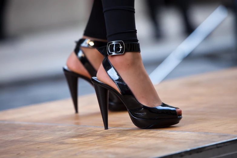 a woman is wearing a pair of high heeled shoes