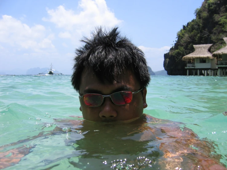 a guy swimming in some crystal clear water