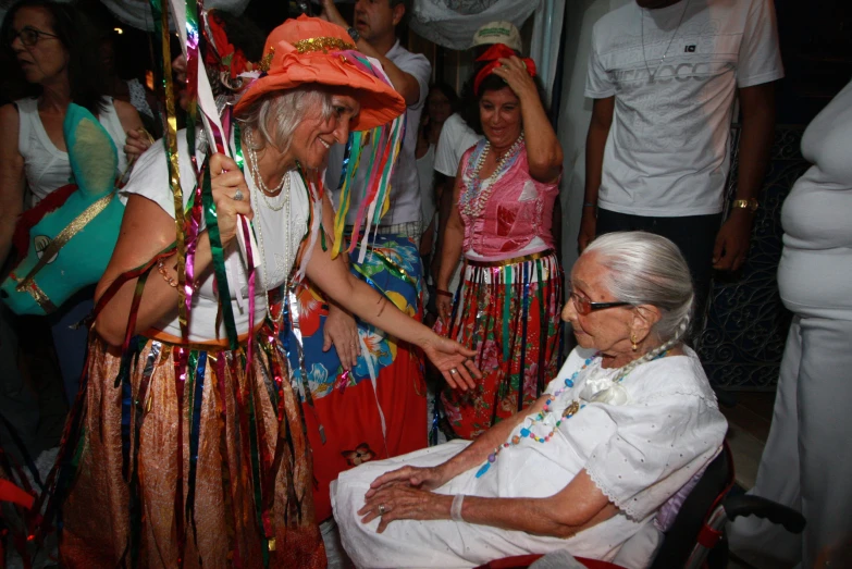 an older person with a costume that has a large pole and ribbons around its neck and arm