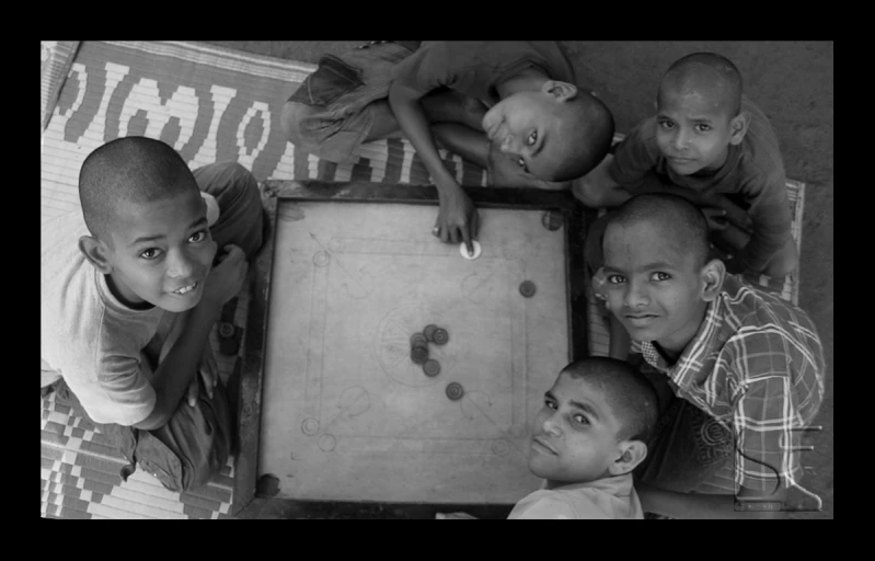 a group of children playing with a board game