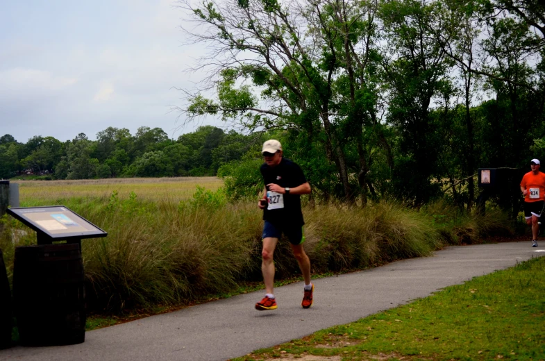 a man running in an event with other runners