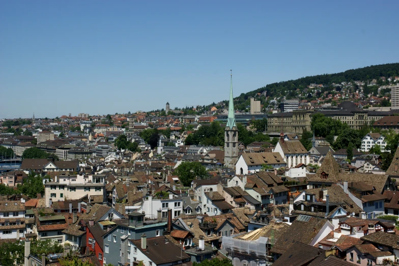 city with several roofs and trees and sky line