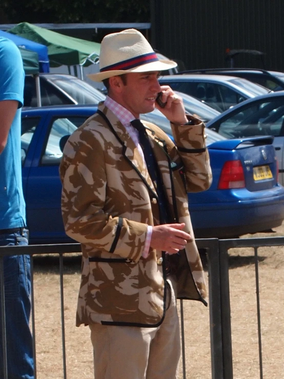 a man is standing outside talking on the phone