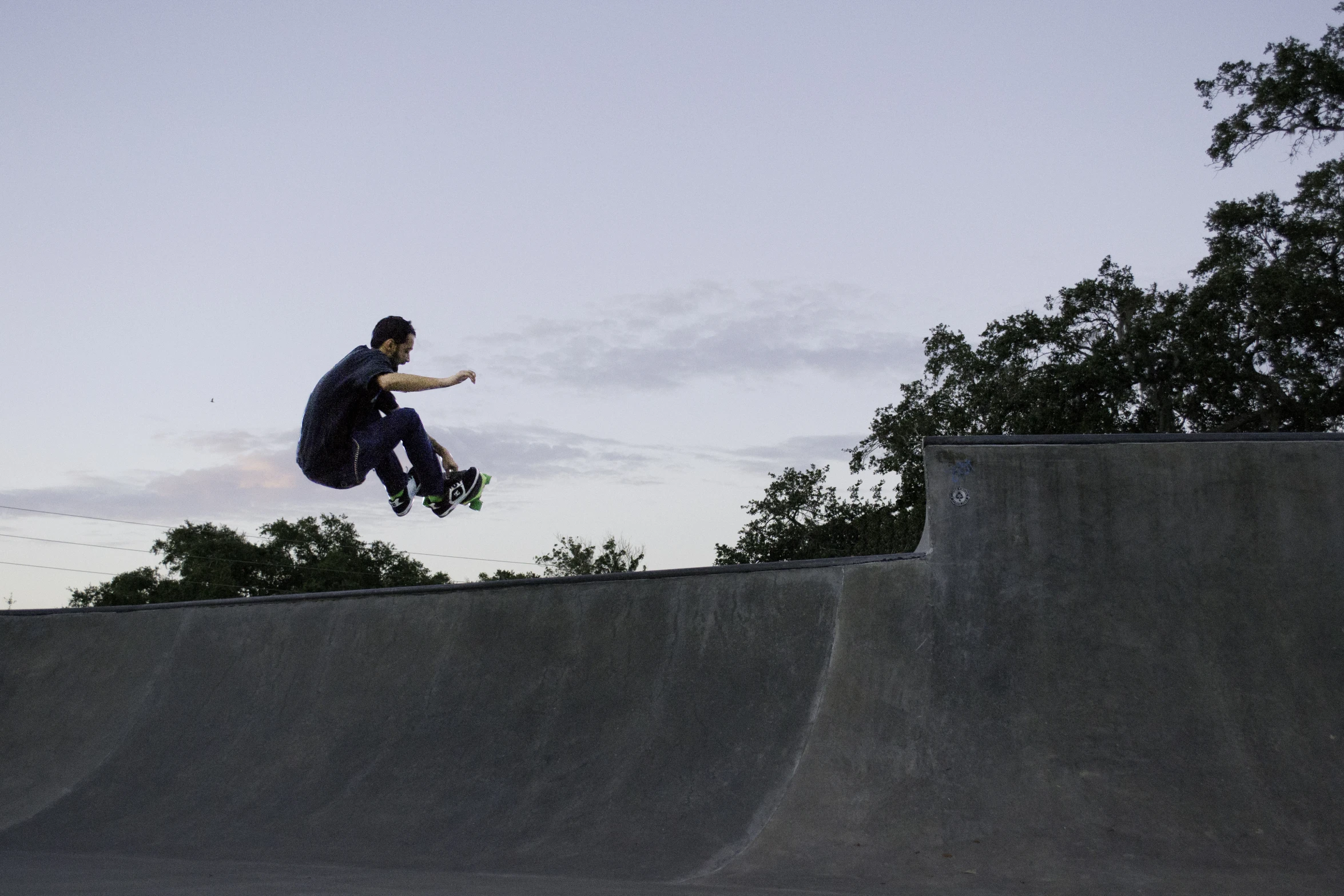 a man on a skateboard jumping over a ramp