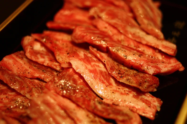 a bunch of bacon sitting on top of a black table