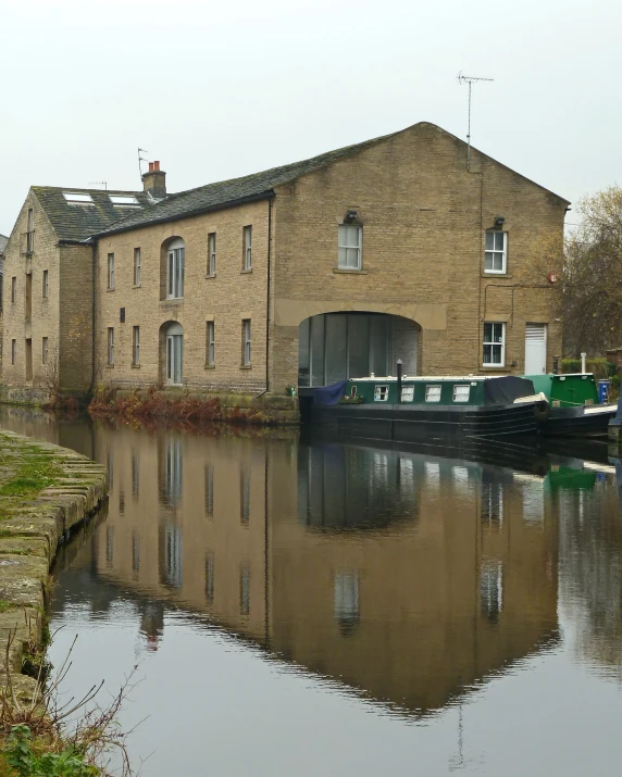 a boat is docked along a river near some buildings