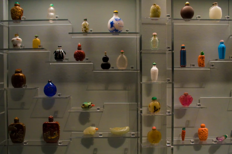 glass bottles on shelving are kept up for display