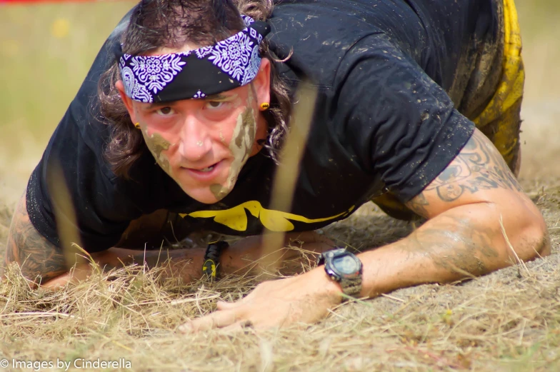 a young man on one leg while standing in the dirt