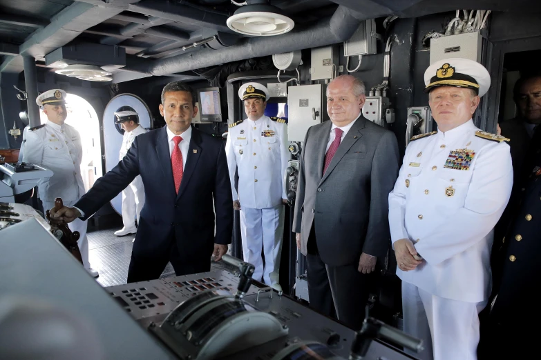 a group of sailors shake hands in the ship